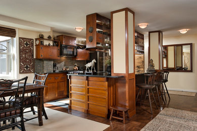 Inspiration for a large asian galley dark wood floor eat-in kitchen remodel in New York with an undermount sink, medium tone wood cabinets, granite countertops, green backsplash, matchstick tile backsplash, black appliances and an island