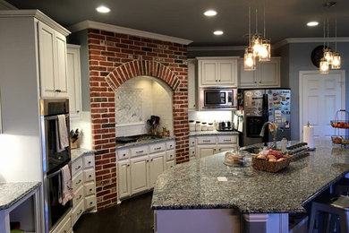 Eat-in kitchen - large industrial u-shaped dark wood floor eat-in kitchen idea in Dallas with a double-bowl sink, raised-panel cabinets, white cabinets, white backsplash, subway tile backsplash, stainless steel appliances and an island