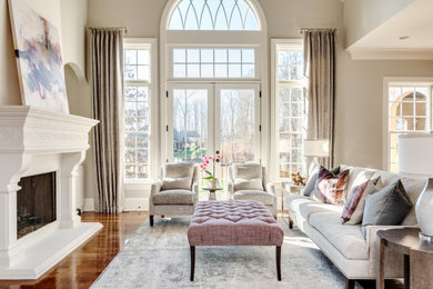Inspiration for a mid-sized transitional open concept dark wood floor, brown floor and vaulted ceiling living room remodel in Charlotte with a standard fireplace, a concrete fireplace and gray walls