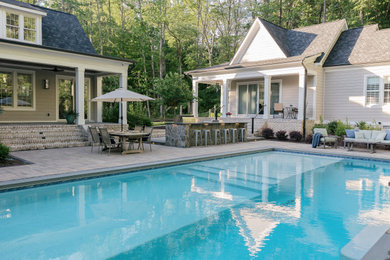Large elegant backyard concrete paver and rectangular pool photo in Richmond with a bbq area