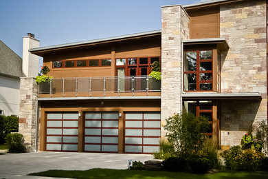 Inspiration for a large modern attached three-car garage remodel in Denver