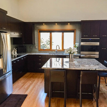 Cherry cabinets with slab doors, a custom-mixed stain, Bianco Antico granite and