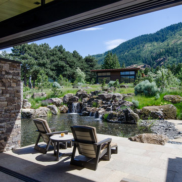 View of inner courtyard and waterfall from Living Room with Guest House beyond