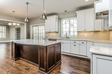 Large transitional light wood floor and brown floor open concept kitchen photo in New York with a drop-in sink, shaker cabinets, beige backsplash, an island and white countertops