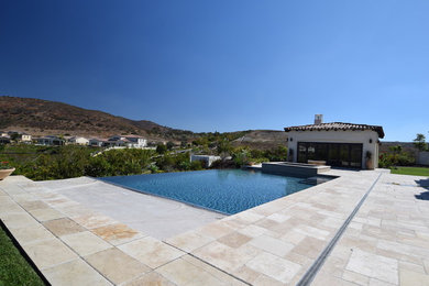 Mid-sized minimalist backyard tile and rectangular infinity hot tub photo in San Diego