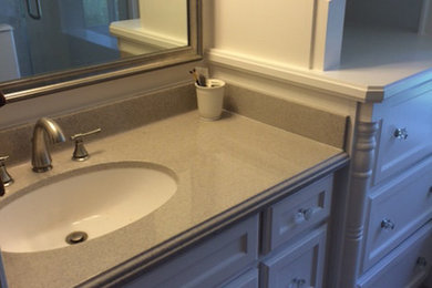Inspiration for a small timeless 3/4 ceramic tile and gray floor bathroom remodel in Houston with shaker cabinets, beige cabinets, gray walls, an undermount sink and laminate countertops