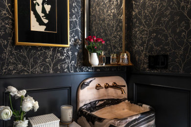 Inspiration for a transitional multicolored floor, wainscoting and wallpaper powder room remodel in Houston with black walls, a console sink and multicolored countertops