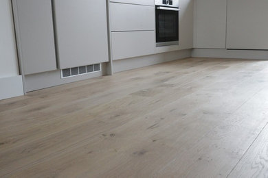 Design ideas for a scandi kitchen in Cambridgeshire with light hardwood flooring.