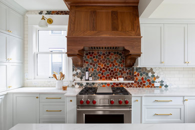 Large transitional u-shaped light wood floor and beige floor eat-in kitchen photo in Minneapolis with a farmhouse sink, recessed-panel cabinets, blue cabinets, quartz countertops, multicolored backsplash, ceramic backsplash, stainless steel appliances, an island and white countertops