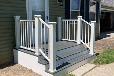 This is an example of a small contemporary mixed material railing porch design in Detroit.