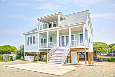 Inspiration for a large coastal green three-story house exterior remodel in Other with a shingle roof and a gray roof