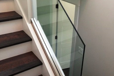 Staircase - wooden straight glass railing staircase idea in Toronto
