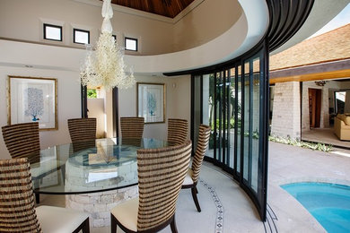 This is an example of a beach style dining room in Other.