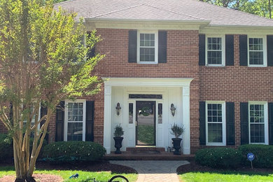 Example of a mid-sized trendy home design design in Charlotte