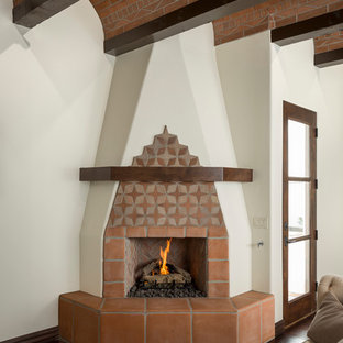Design ideas for a medium sized mediterranean formal enclosed living room in Phoenix with white walls, dark hardwood flooring, a corner fireplace, a tiled fireplace surround and no tv.