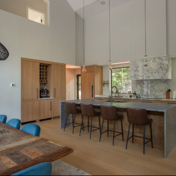 High Ceiling Open Kitchen & Dining Space – Oak Cabinetry & Marble Waterfall Isla