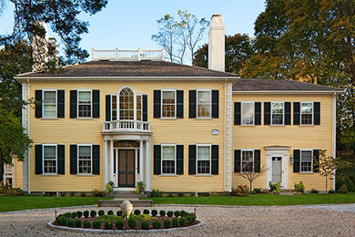 Example of a large classic yellow two-story wood exterior home design in Boston