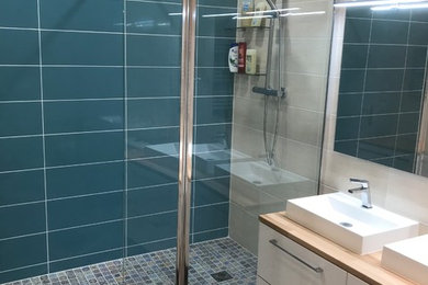 Exemple d'une salle de bain principale tendance de taille moyenne avec un placard à porte plane, des portes de placard blanches, une douche ouverte, WC à poser, un carrelage multicolore, des carreaux de céramique, un mur multicolore, un sol en vinyl, une vasque, un plan de toilette en bois, un sol marron, meuble double vasque et meuble-lavabo suspendu.