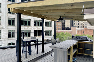 Inspiration for a mid-sized contemporary rooftop rooftop cable railing deck remodel in Cleveland with a bbq area and a pergola