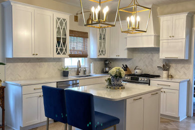 Example of a mid-sized transitional l-shaped kitchen design in Other with shaker cabinets, white cabinets, quartz countertops, an island and white countertops