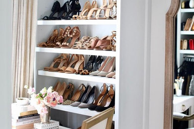 Inspiration for an eclectic women's walk-in wardrobe in New York with grey cabinets.