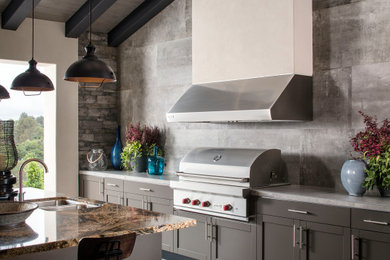 Inspiration for a transitional patio kitchen remodel in Miami with a roof extension