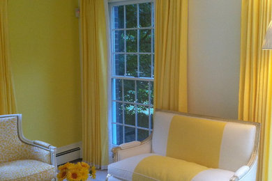 Example of a mid-sized classic enclosed light wood floor living room design in New York with yellow walls and no fireplace