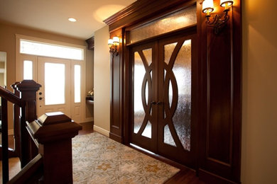 Inspiration for a timeless medium tone wood floor foyer remodel in Edmonton