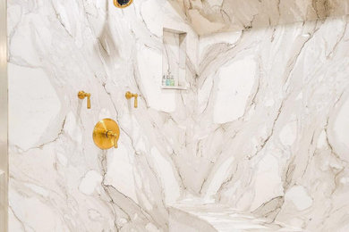 Example of a large trendy master marble tile marble floor, multicolored floor, double-sink, vaulted ceiling and wall paneling bathroom design in DC Metro with recessed-panel cabinets, beige cabinets, a two-piece toilet, gray walls, an undermount sink, marble countertops, white countertops and a built-in vanity