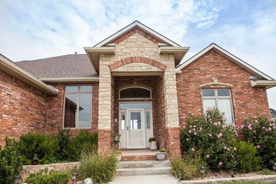 Red two-story mixed siding exterior home photo in Wichita