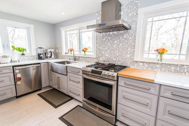 Photo of a large transitional u-shaped separate kitchen in Boston with a drop-in sink, grey cabinets, quartz benchtops, grey splashback, mosaic tile splashback, stainless steel appliances, porcelain floors and with island.