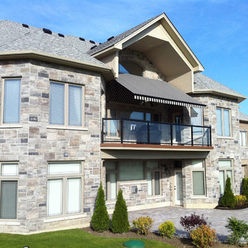 Retractable awning over balcony