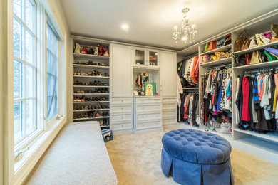 Inspiration for a large traditional women's dressing room in Minneapolis with recessed-panel cabinets, light wood cabinets and carpet.