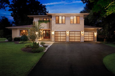 Large trendy attached three-car garage photo in Raleigh