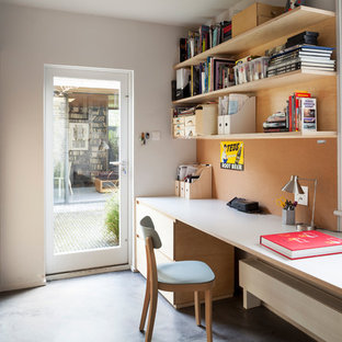 Design ideas for a contemporary home office and library in London with white walls and a built-in desk.