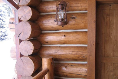 Example of a large mountain style brown two-story wood gable roof design in Denver