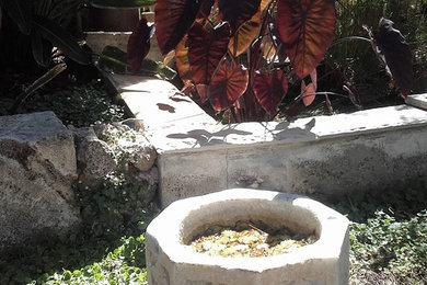 Small mediterranean courtyard partial sun xeriscape in Other with a water feature and natural stone pavers for summer.