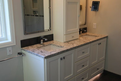 Inspiration for a mid-sized modern master ceramic tile corner shower remodel in Minneapolis with white cabinets, white walls, an undermount sink and granite countertops
