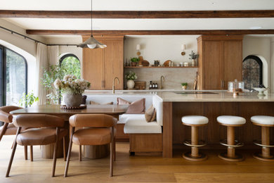 Inspiration for an expansive traditional galley open plan kitchen in Hertfordshire with a submerged sink, shaker cabinets, dark wood cabinets, beige splashback, medium hardwood flooring, an island, brown floors and beige worktops.