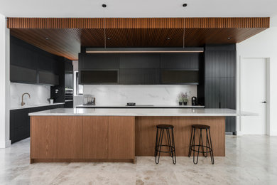 This is an example of a contemporary kitchen in Sydney with an island.