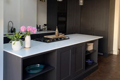 This is an example of a large contemporary single-wall kitchen/diner in Other with a submerged sink, concrete worktops, white splashback, an island and white worktops.