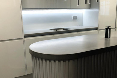 This is an example of a medium sized modern kitchen in Other with concrete worktops and an island.