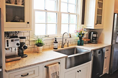 Large farmhouse l-shaped dark wood floor eat-in kitchen photo in Nashville with a farmhouse sink, white cabinets, granite countertops, white backsplash, subway tile backsplash, stainless steel appliances, recessed-panel cabinets and an island
