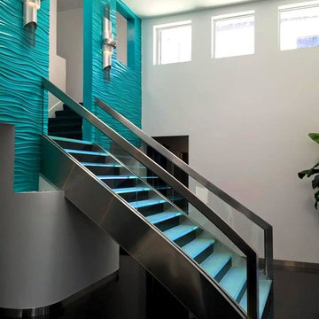 Stainless Staircase with bent glass and LED backlit glass steps