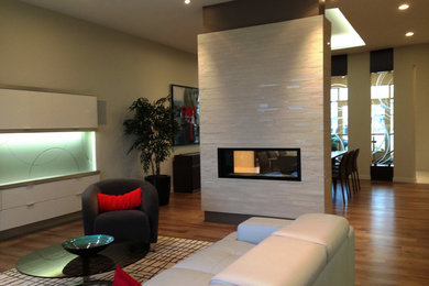Inspiration for a large contemporary open concept medium tone wood floor living room remodel in Other with beige walls, a ribbon fireplace and a tile fireplace