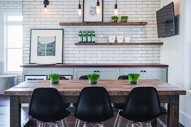 Example of a mid-sized mountain style medium tone wood floor kitchen/dining room combo design in Other with white walls