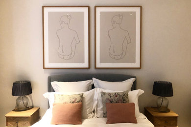 Photo of a medium sized contemporary master bedroom in London with pink walls and carpet.