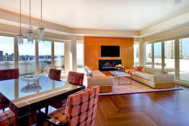 Inspiration for a mid-sized contemporary loft-style medium tone wood floor living room remodel in Phoenix with white walls, a standard fireplace, a wood fireplace surround and a wall-mounted tv