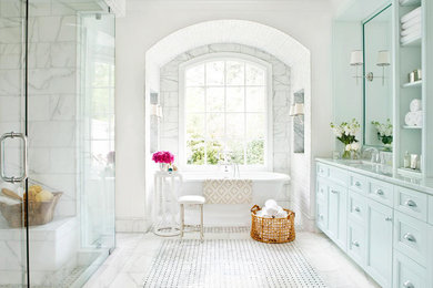Inspiration for a large transitional master white tile and marble tile mosaic tile floor and multicolored floor bathroom remodel in DC Metro with furniture-like cabinets, white cabinets, a one-piece toilet, white walls, an undermount sink, granite countertops, a hinged shower door and white countertops