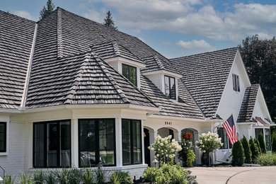 Example of a french country home design design in Minneapolis
